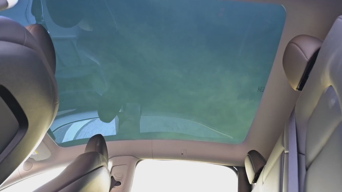 A vehicle's glass roof switching between a frosted, light-diffusing state and clear